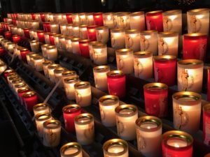 White and red vigil candles in Notre-Dame de Paris