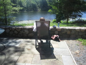 Woman in a chair looking out over a lake